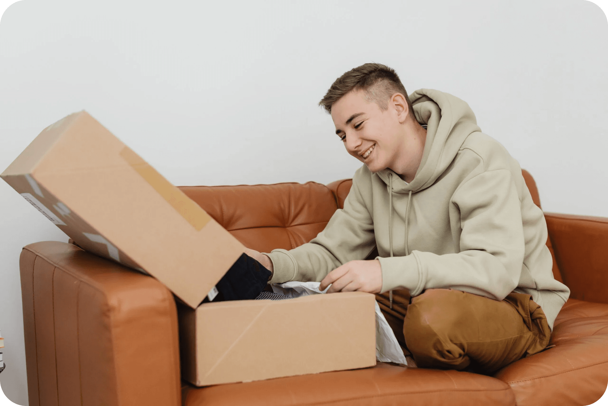 A Man smiling opening a box